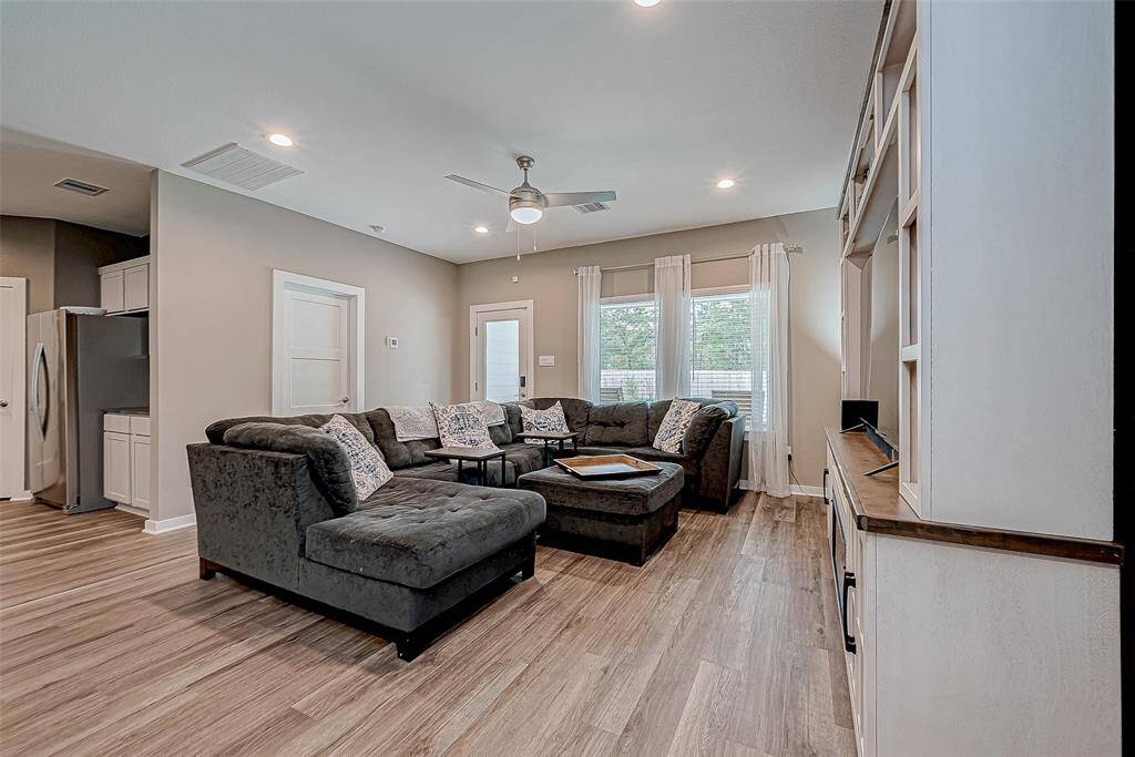Experience seamless indoor-outdoor living in this inviting family room, offering stunning views of the backyard, pool, and patio.