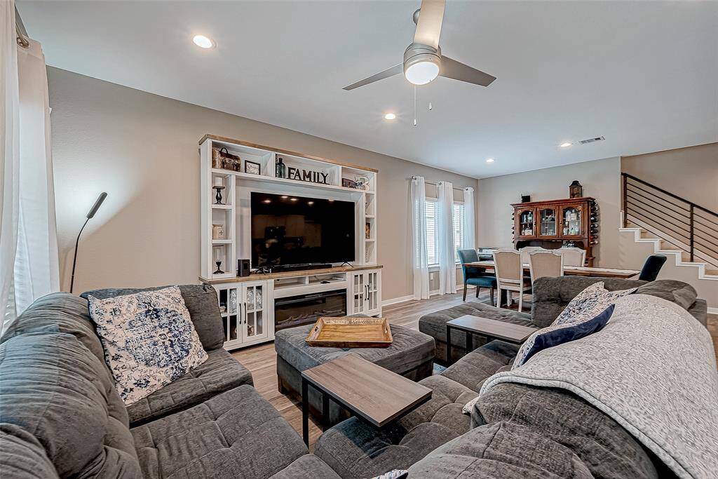 Enjoy a seamless flow From the back door into the dining area, stairs leading to the game room, and three additional second-floor bedrooms.