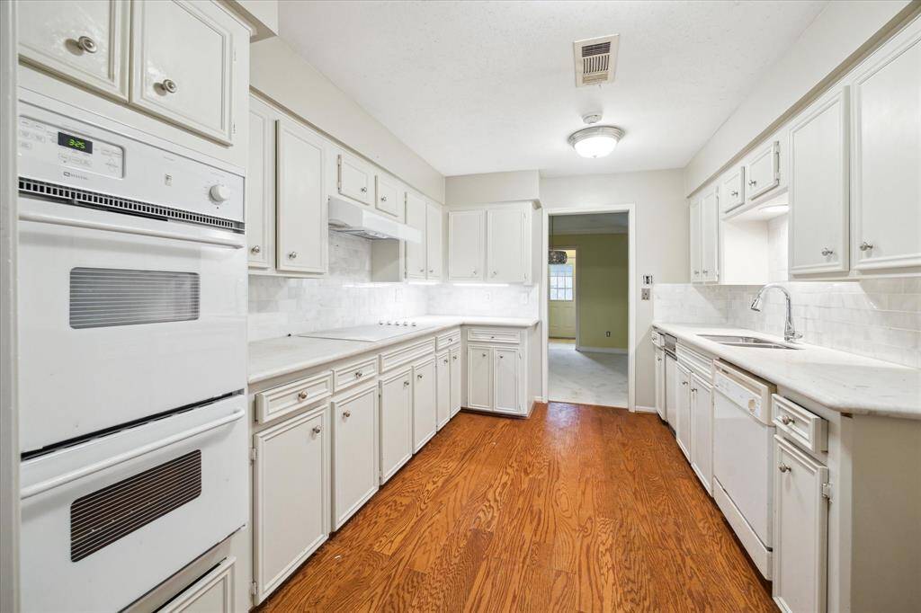 Sleek granite countertops and ample cabinetry make this kitchen a dream for cooking and entertaining.