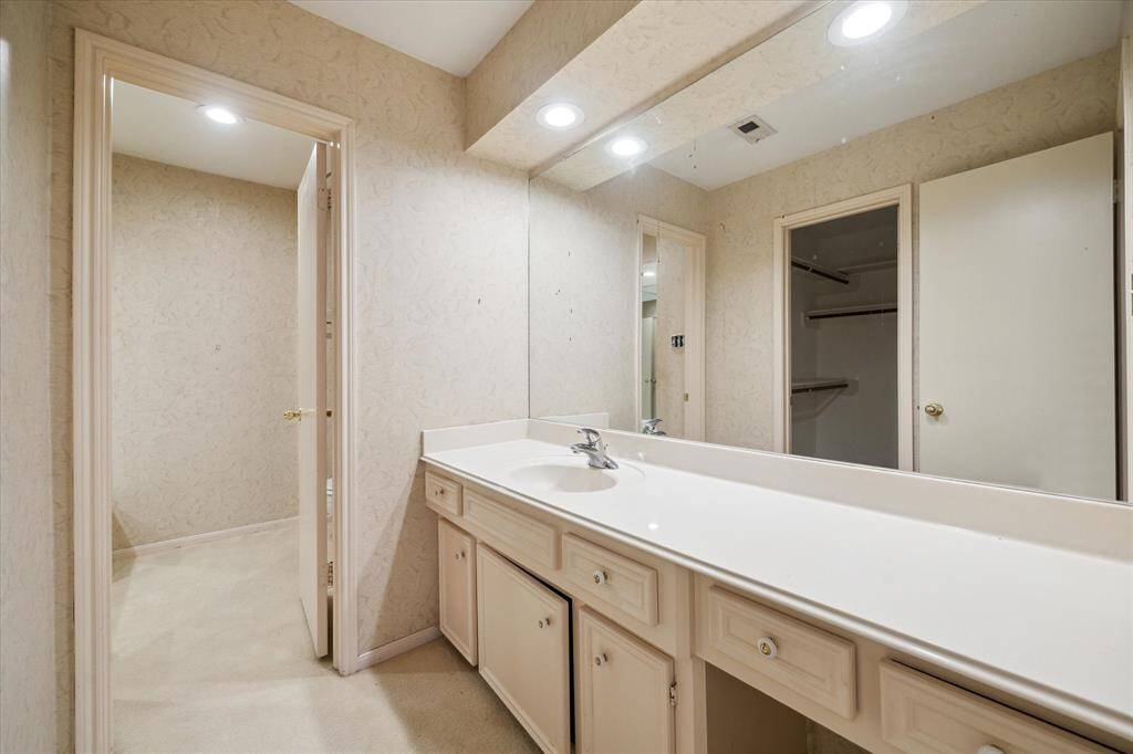 Large primary bathroom with a spacious vanity and plenty of storage for everyday convenience.