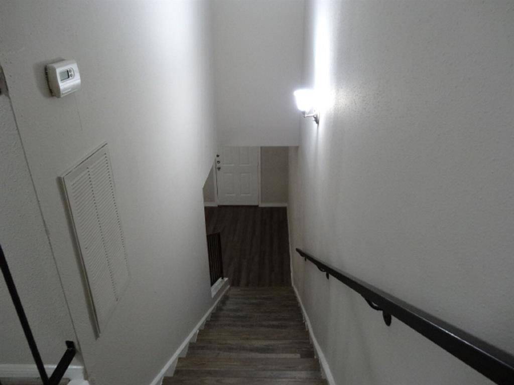 Heading Down the Well Lit Laminate Stairwell