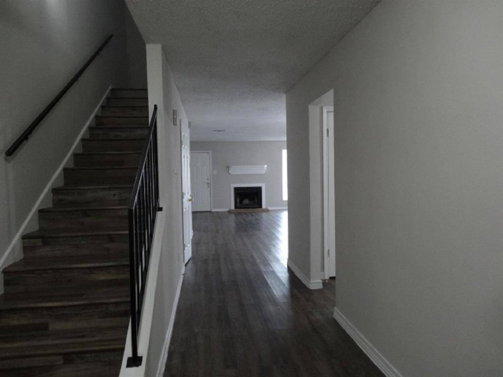 Laminate Flooring on Stairs w/Glimpse of Fireplace