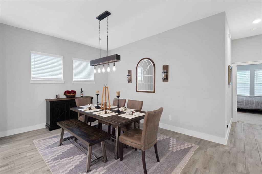 This modern home includes this spacious dining area that is open to the kitchen and living room which is just perfect for entertaining.
