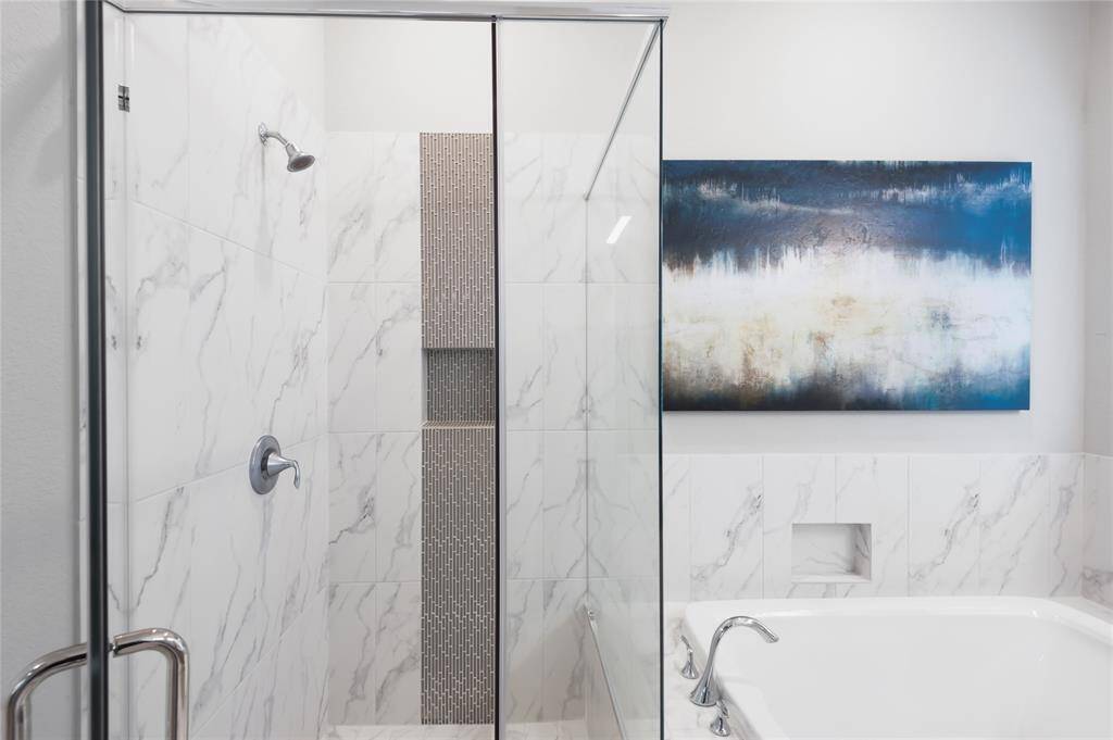 The shower with accent tile is just gorgeous.   This bathroom is serene and spacious.