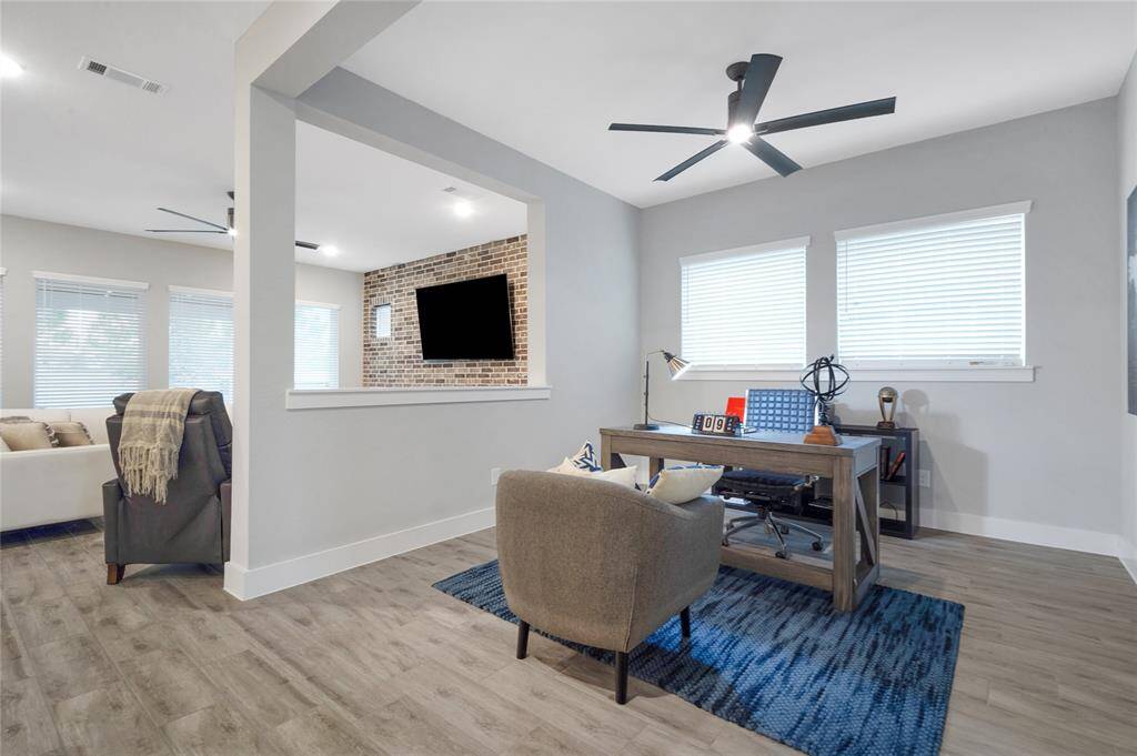 Another view of the spacious open floor plan and flex room with a peek into the light and bright living room.