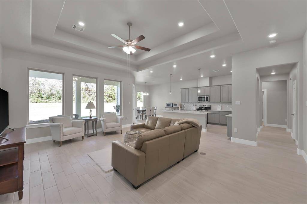 Very open floorplan with tray ceilings & tile wood look flooring