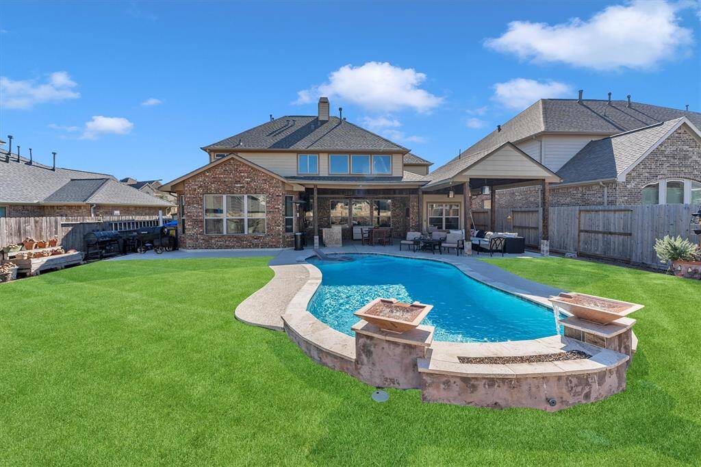 Explore this charming home with a spacious backyard, featuring a pristine pool, lush lawn, and a covered patio perfect for entertaining. The brick exterior offers timeless appeal and durability.