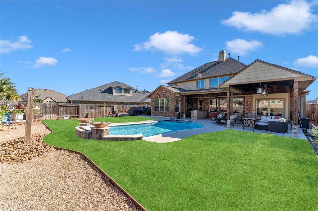 Explore the perfect outdoor oasis with a spacious patio, inviting pool, and pristine lawn—ideal for relaxation and entertaining.