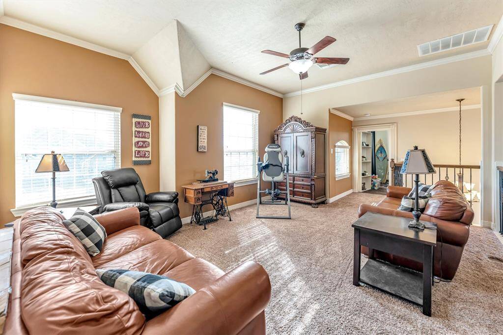 Bright and spacious living area features plush carpeting, generous seating areas, and large windows for abundant natural light. With a ceiling fan and ample storage, it’s perfect for relaxation and entertaining.