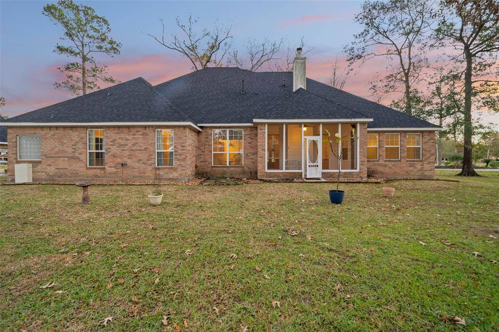 back of the home with screened in back porch