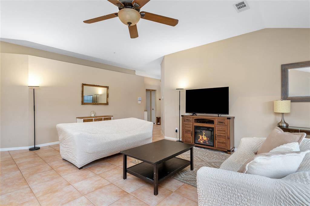 Whether you're reading a good book, watching TV, or simply enjoying the warmth of the fireplace, this space provides the perfect setting to relax and unwind in comfort.