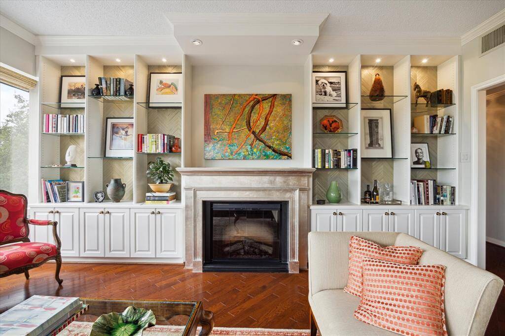 Note the beautiful finishes on this custom wall of shelves and fireplace.