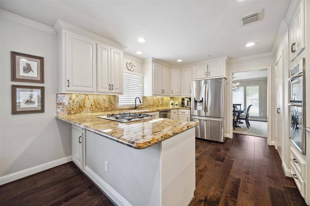 Den off of formal entry with views of front yard and back
