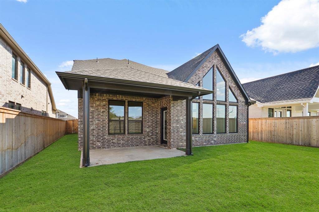 This outdoor covered patio is a relaxing space to grill and enjoy the beautiful outdoors. Private brick wall fence off the back of the home with views to the lush and expansive greenspace in the rear!