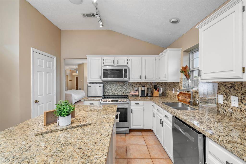From this vantage point, you can appreciate the open layout of the kitchen and dining area, seamlessly flowing into the living room. Whether you're cooking, dining, or entertaining, this design allows you to stay connected with the action in the living room, ensuring you never feel left out of the conversation or the fun.