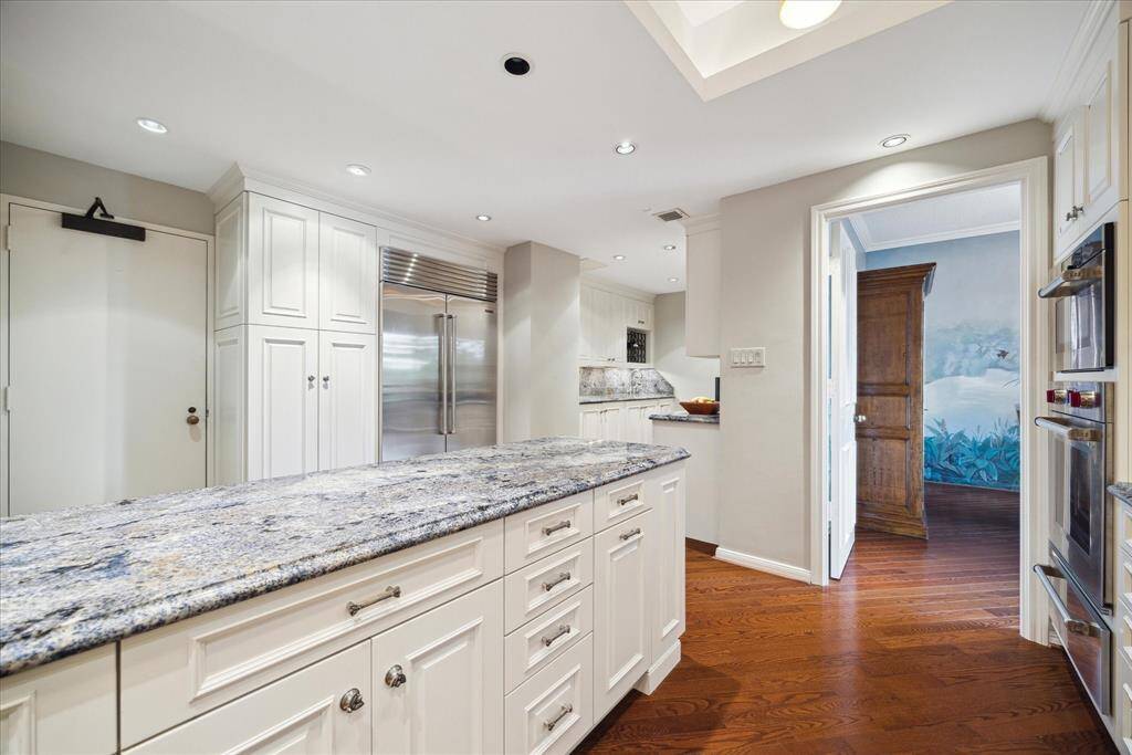 Another view of kitchen .  Area at end of room is storage, prep area, second sink.