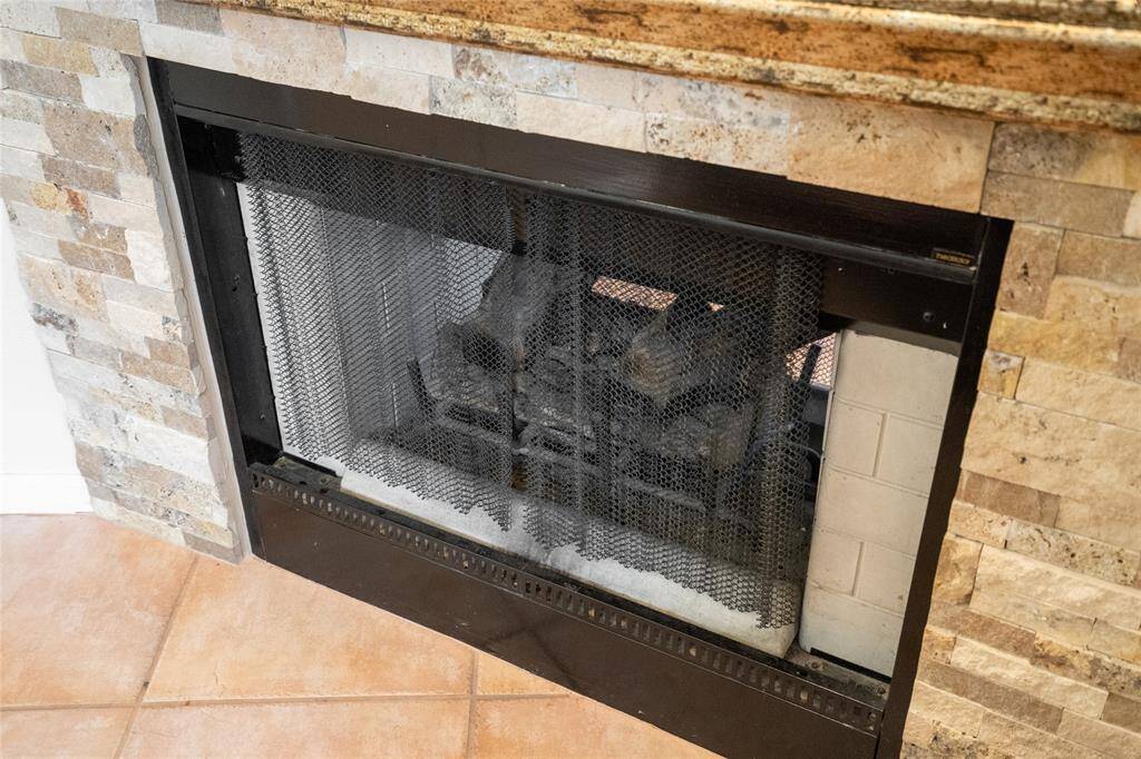 Here’s a close-up of one of the fireplaces, highlighting its timeless design and inviting warmth. The elegant mantel and cozy flames create a perfect focal point, adding both charm and comfort to the living space.