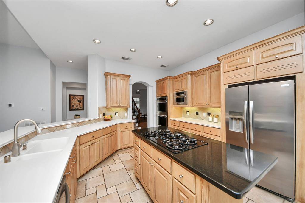 Ample counter top space for cooking, cabinet space for all the appliance and a gas cook top with downdraft ventilation that escapes to the outside.