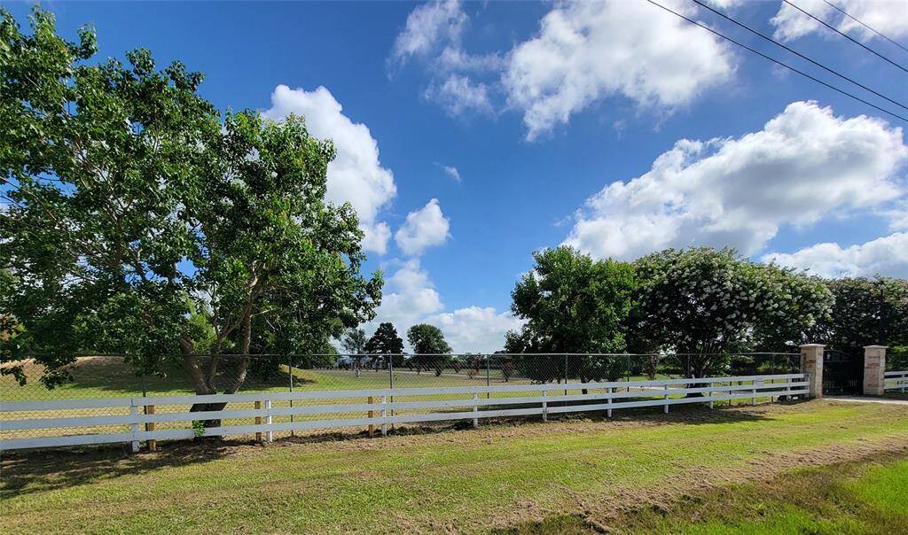 White cross fence at front perimeter of property.