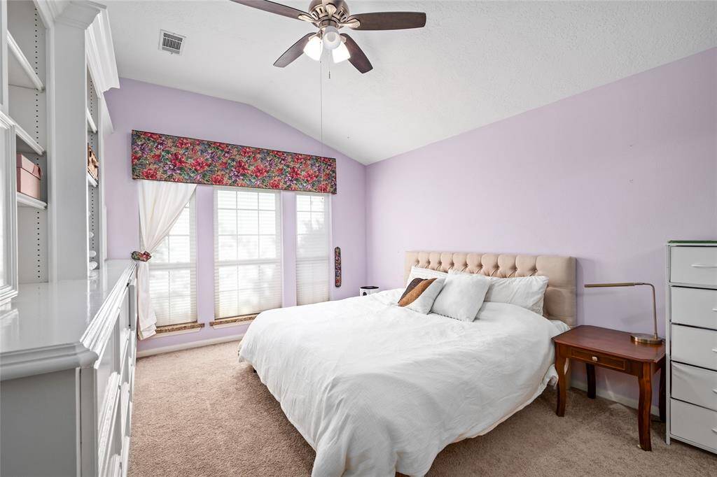 The primary bedroom is your personal retreat, offering comfort and relaxation after a long day’s work. Spacious and inviting, it features soft carpet underfoot, built-in cabinets for added storage, and light-colored paint tones that enhance the room’s peaceful, serene atmosphere.