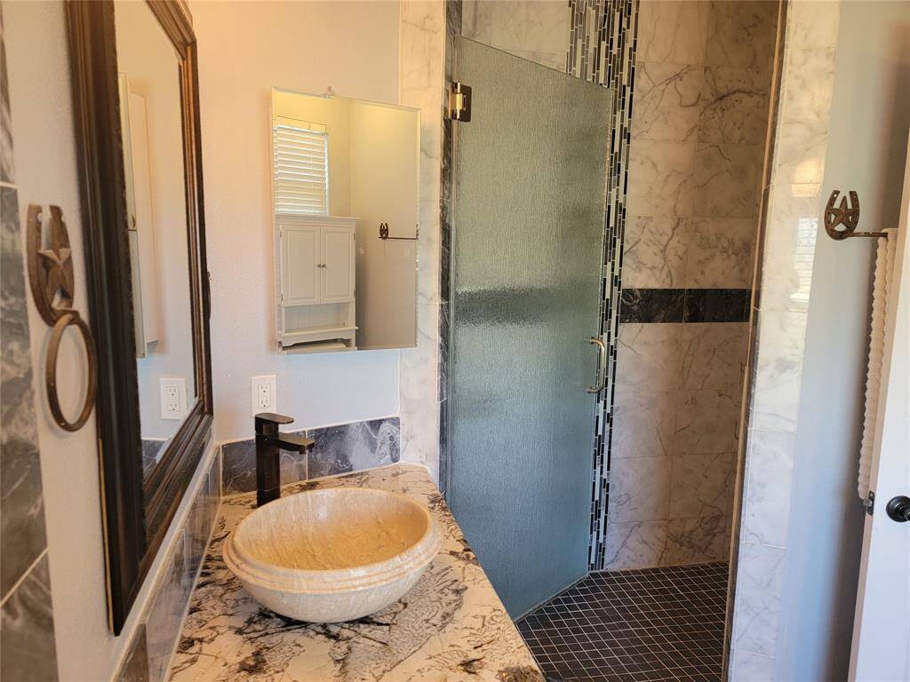 Separate tile shower and beautiful sink bowl.