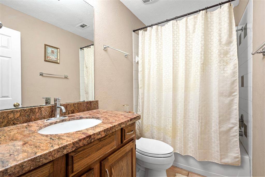 The secondary bathroom features a convenient tub/shower combo, complemented by a sleek frameless mirror. With plenty of cabinet space and ample counter space, this bathroom provides both functionality and style, making it perfect for daily use.