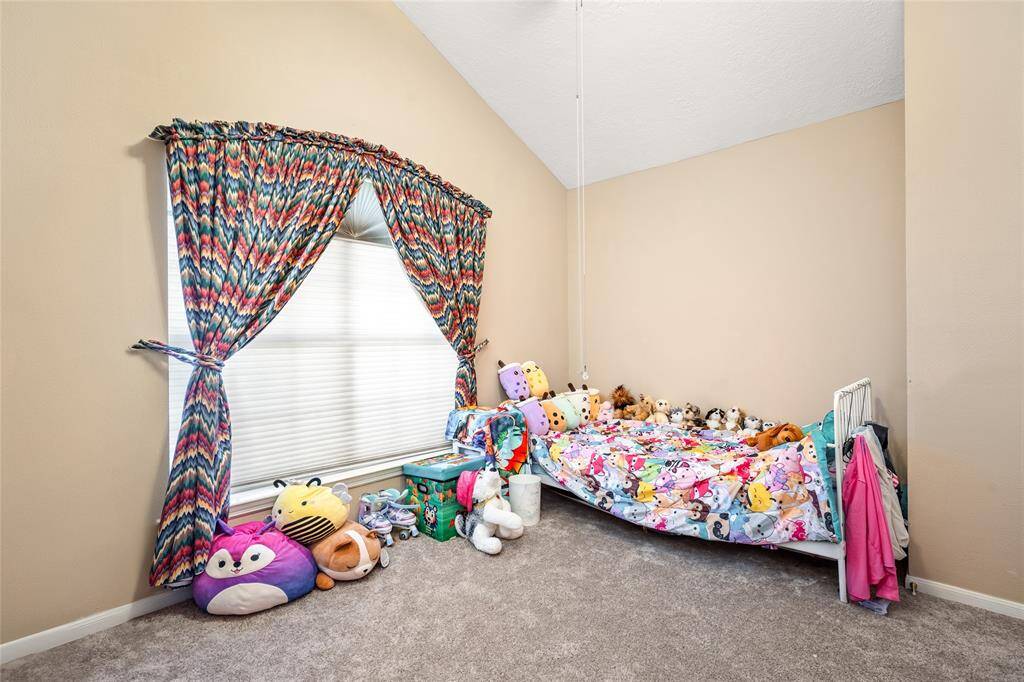 Another secondary bedroom, currently used as a kids' room, features the same earthy tones that create a warm, inviting atmosphere. With its neutral palette, this room offers endless possibilities for you to bring out your inner interior decorator and design a space that perfectly reflects your style and needs.