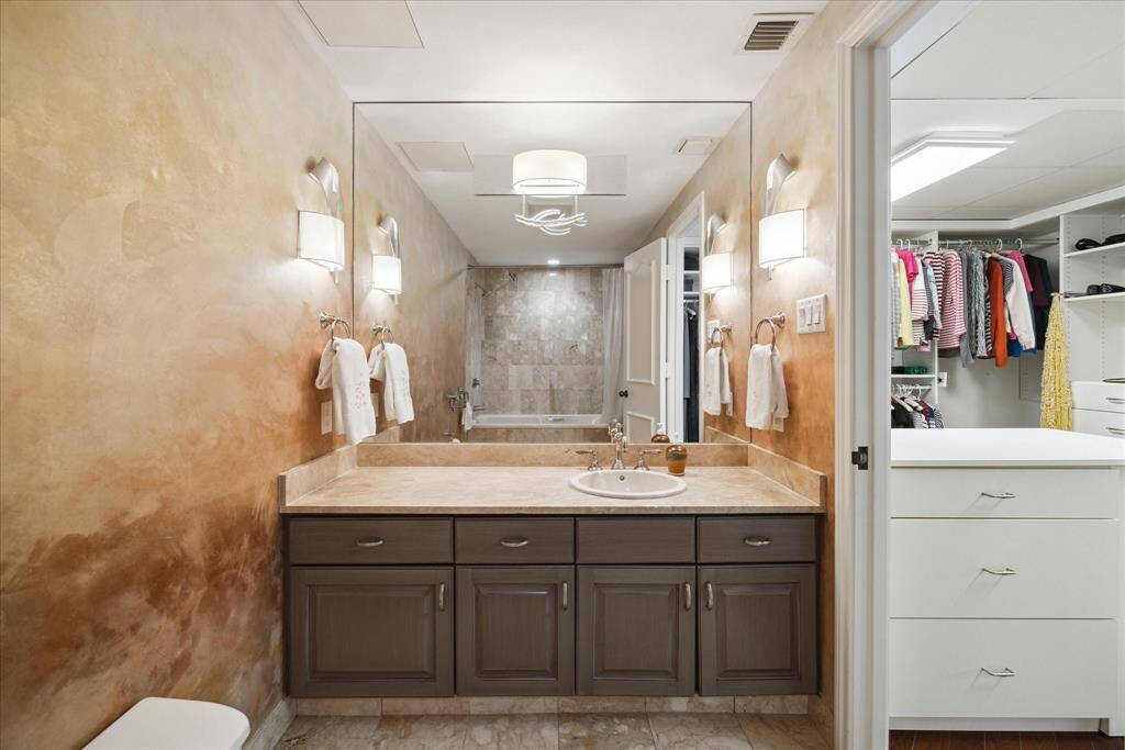 The wallcovering in primary bath is a beautiful gold paper which has to be seen to appreciate.