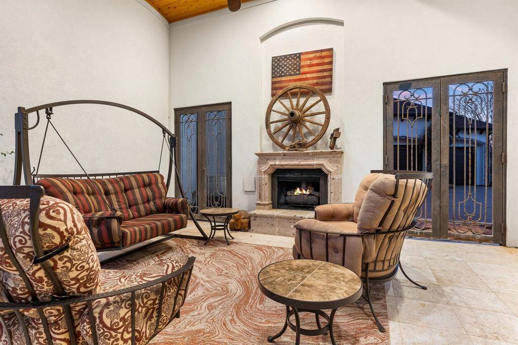 Cozy lanai featuring a built-in fireplace, ideal for outdoor relaxation and entertaining.