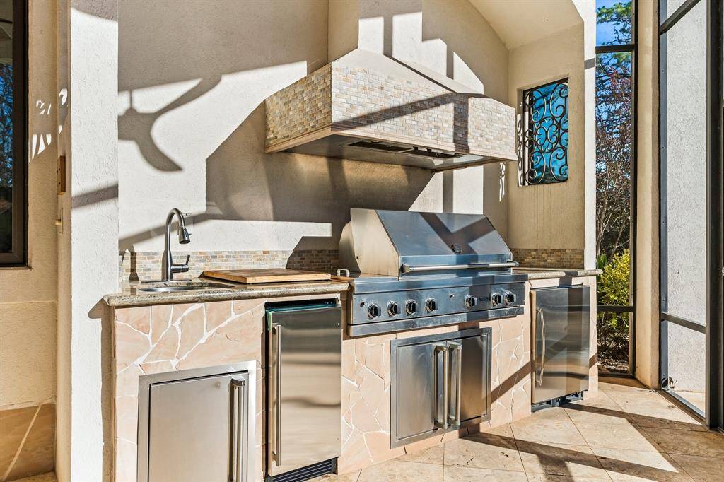 Fully equipped outdoor kitchen, perfect for entertaining, with built-in grill and prep space.