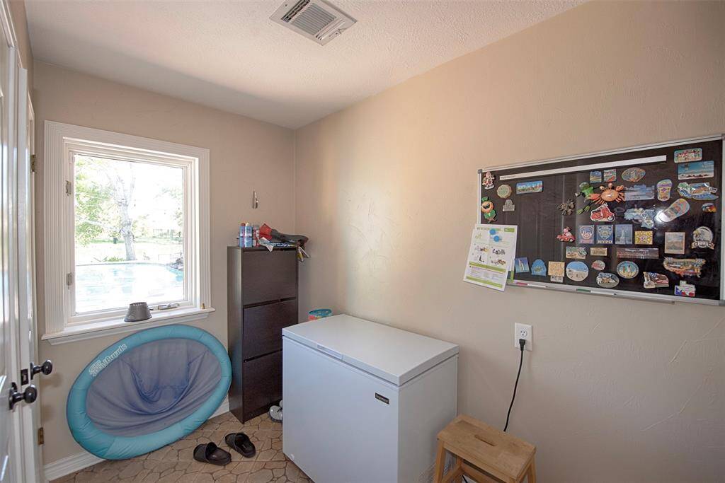 Next to the kitchen is an additional storage area. A great spot for a secondary fridge or maybe a small office area. Room provides additional storage space as well.