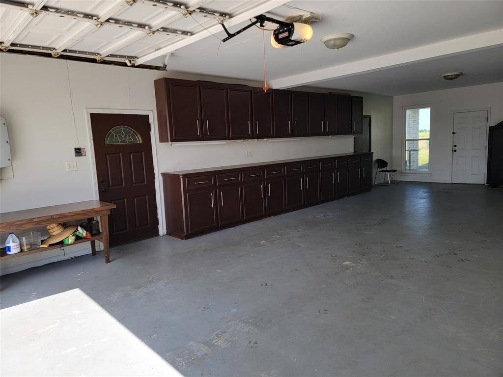 Garage with built in cabinets and incredibly spacious.
