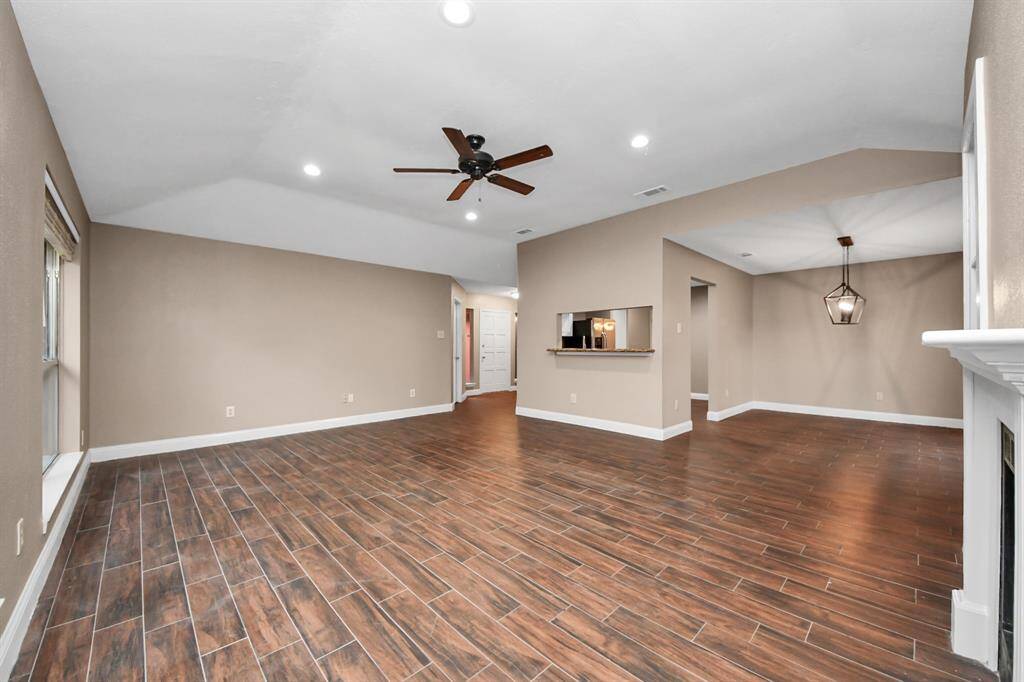 Vaulted high ceilings in living room with cozy fireplace and built ins.