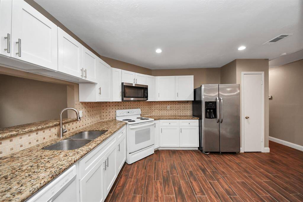 Spacious kitchen comes with fridge. Space here for breakfast nook.