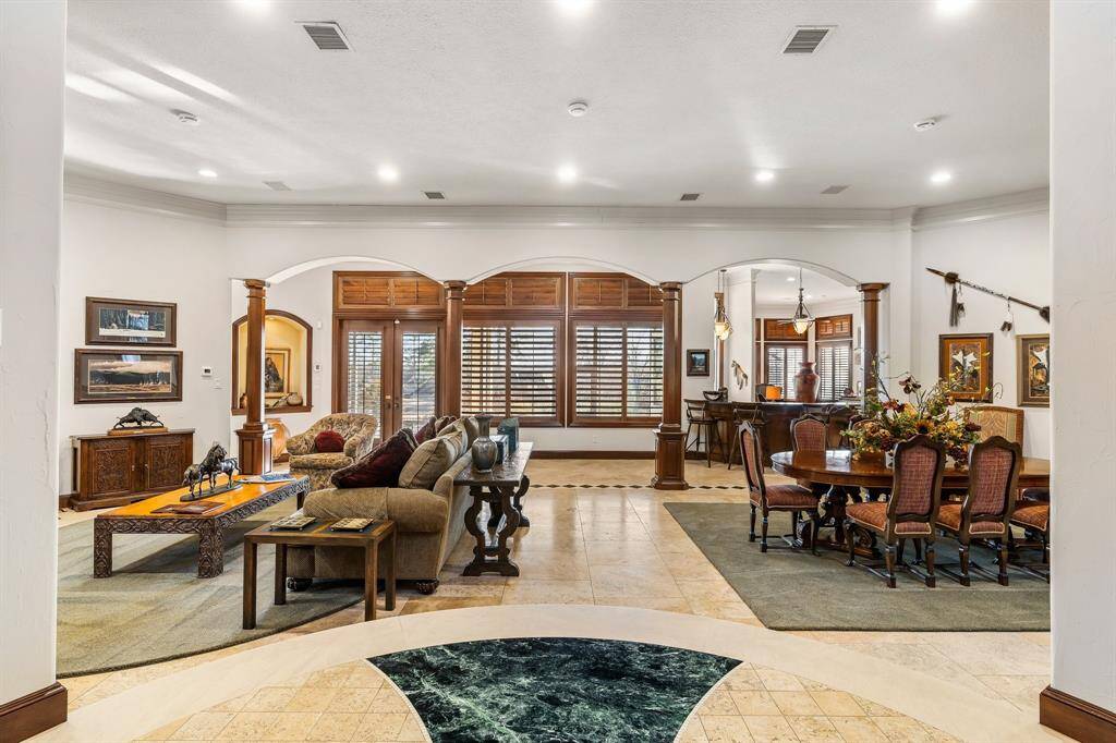 Elegant living space with rich dark wood finishes and large windows.