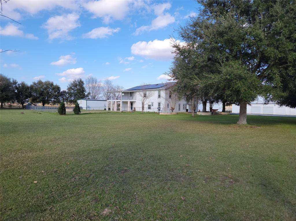 View from property right. Main home center, guest house left, storage/workshops right.