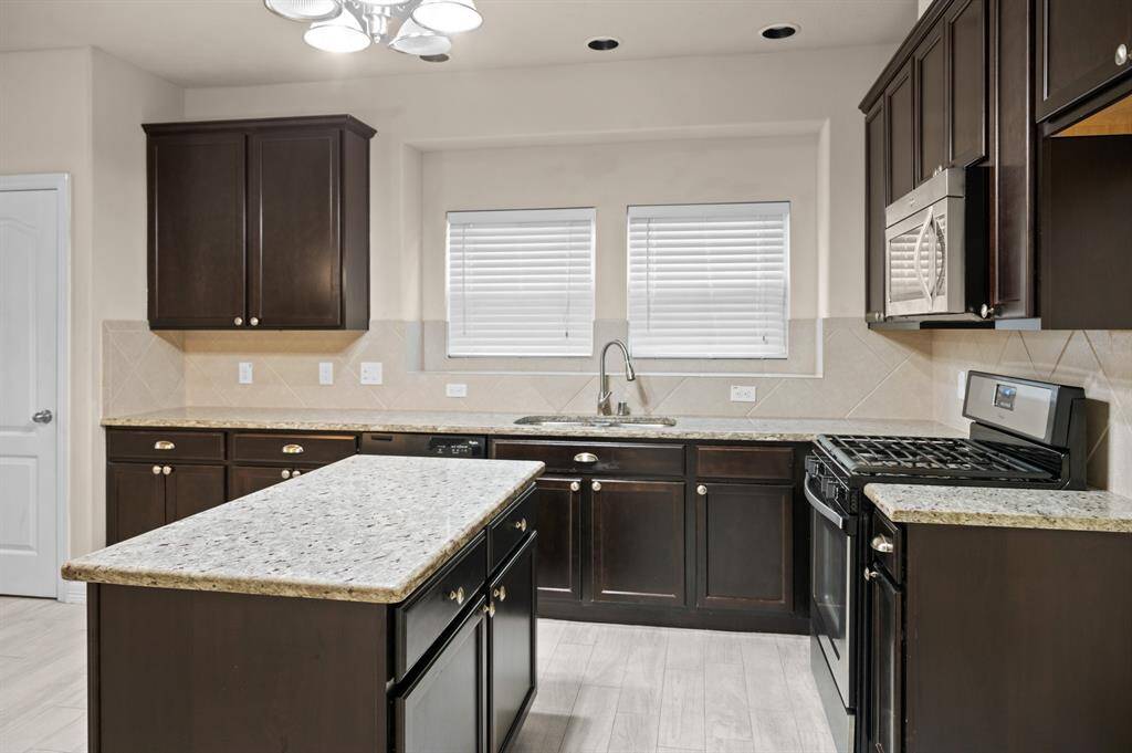 This inviting kitchen, with its spacious countertops and cozy vibe, is ready for all your cooking adventures.