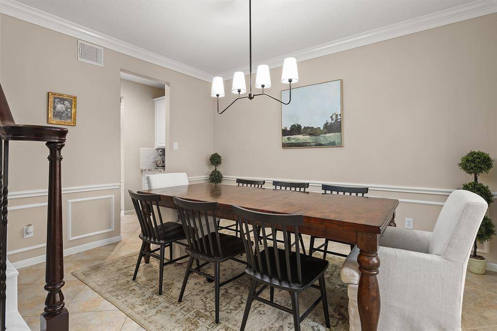Formal Dining with Crown Moulding And Chair Railing