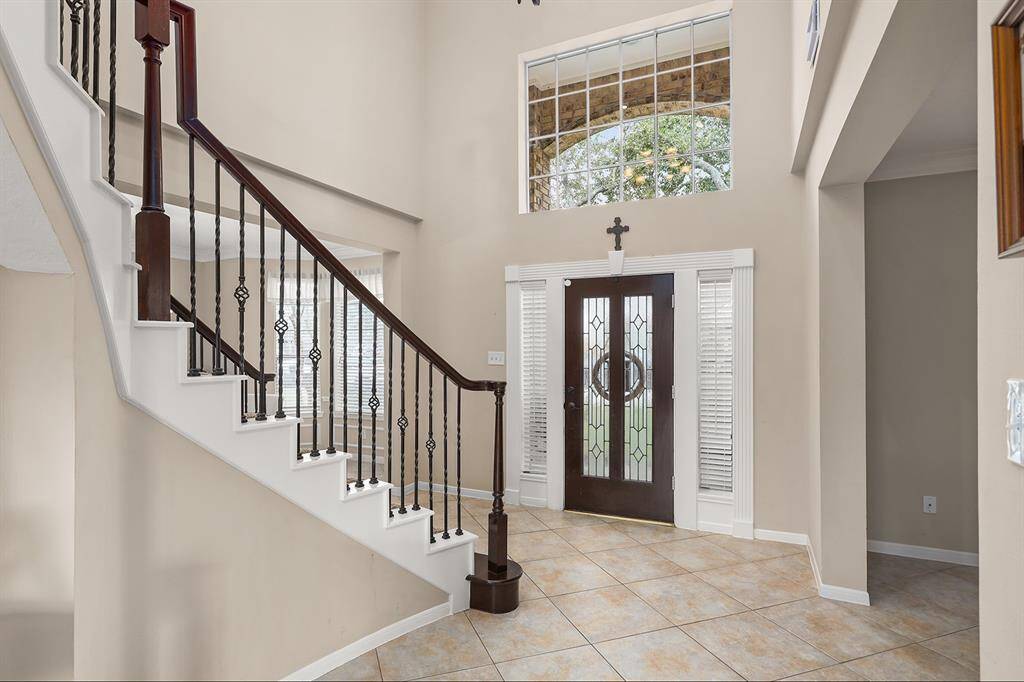 Gracious Entry with Wrought Iron Stair Railing