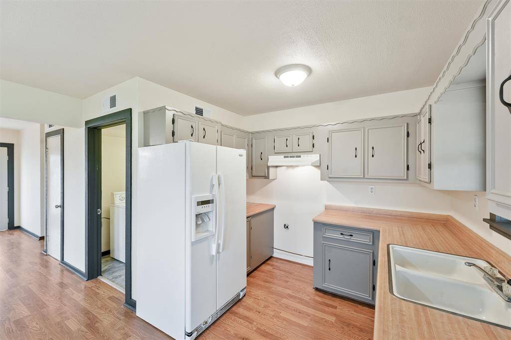 Inside laundry next to kitchen.