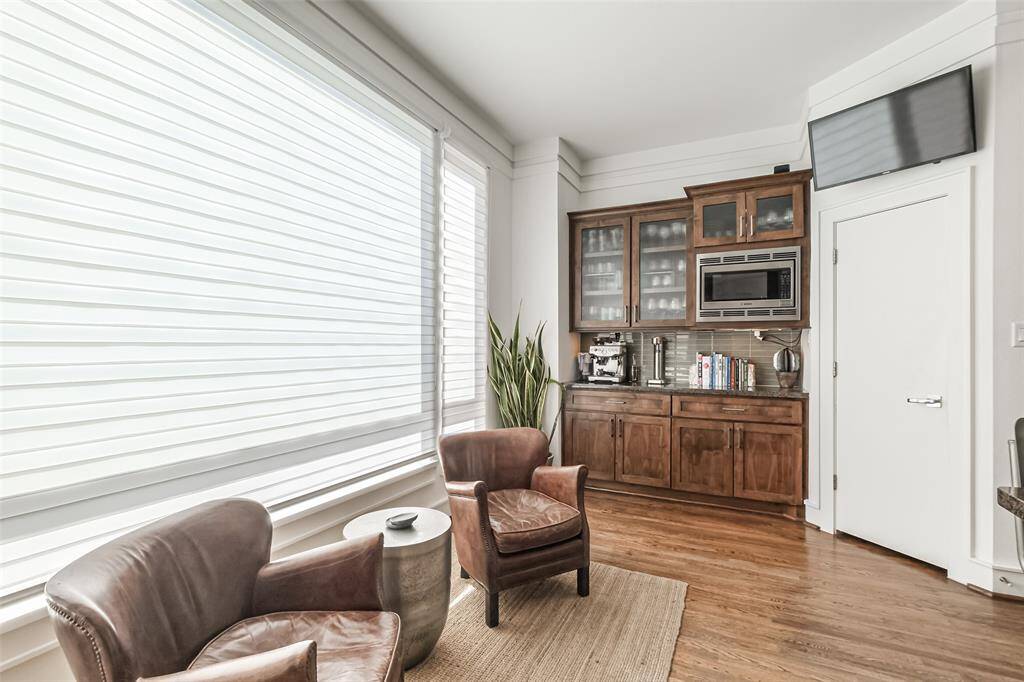 Currently set up as a coffee bar, this could be a great breakfast room as well with the additional counter and cabinet space and microwave close at hand.
