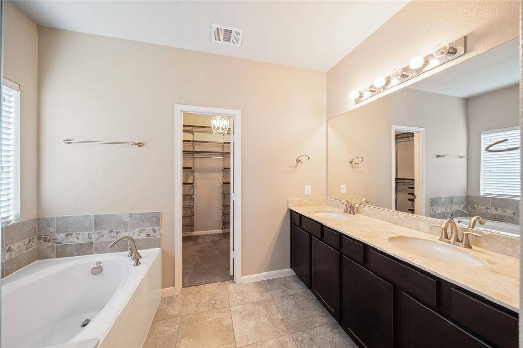 Primary bath has double sinks, soaker tub and separate shower