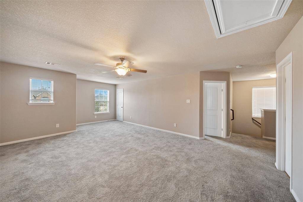 Huge game room on second floor PLUS media room with theatre chairs and equipment off . Open door is one of the 3 bedrooms on second floor.