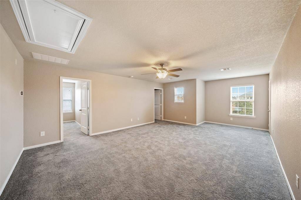 Another view of huge game room showing entrances to two of the secondary bedrooms