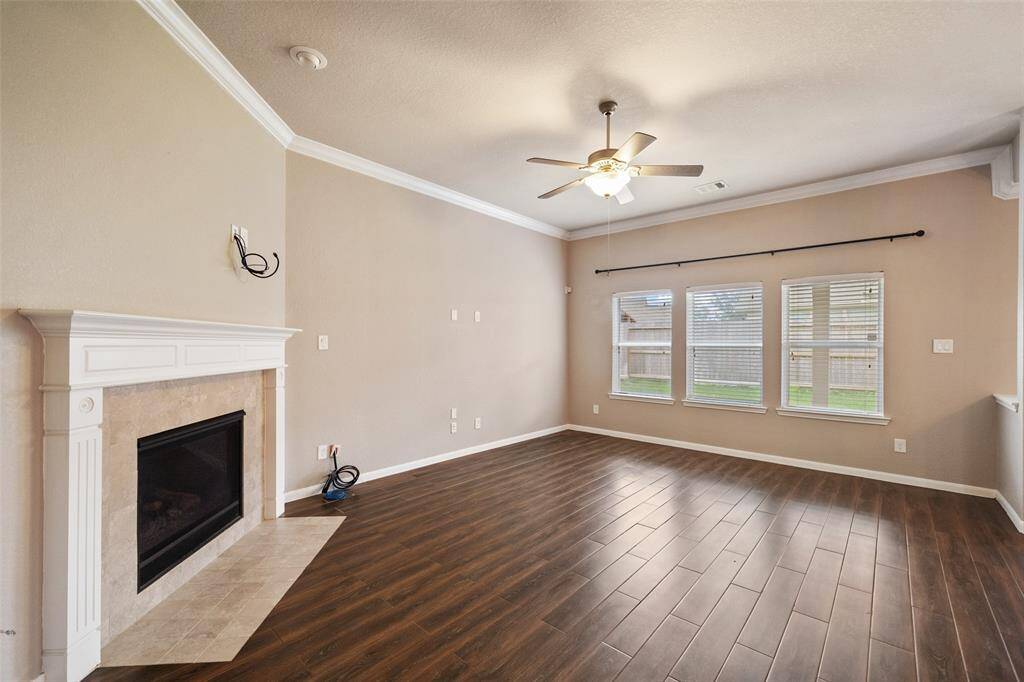 Spacious den overlooks the back yard and has corner fireplace with gas logs and is wired for TV palcement above fireplace