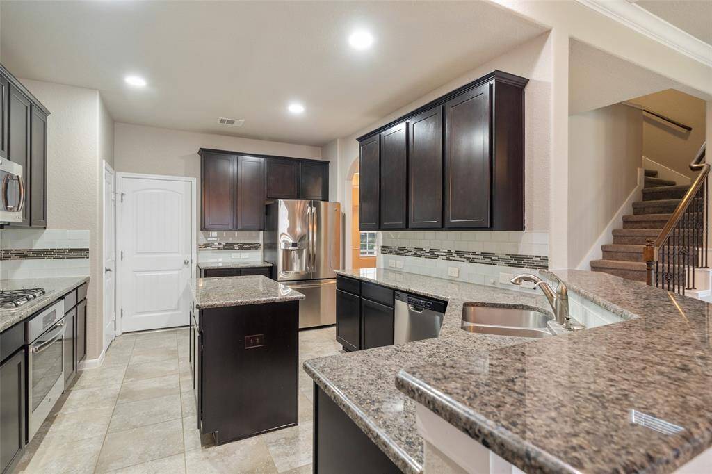 Very spacious island kitchen  with lots of cabinets and plenty of space for more than one cook in the kitchen! Fridge stays!