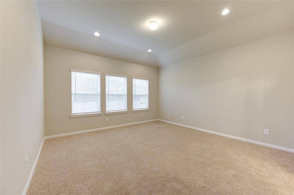 Relax in the primary bedroom at the end of a long work day or night ...