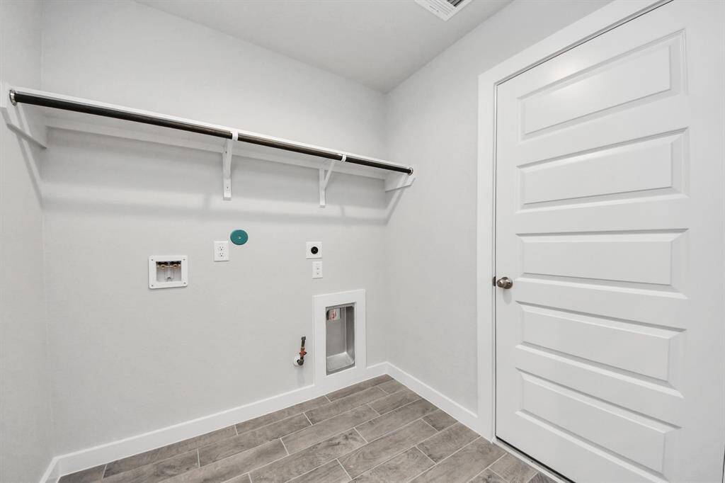 A perfect blend of functionality and comfort. Capture the essence of easy living with a first-floor laundry room, thoughtfully equipped with shelving for effortless organization. Both electric and gas connections available.