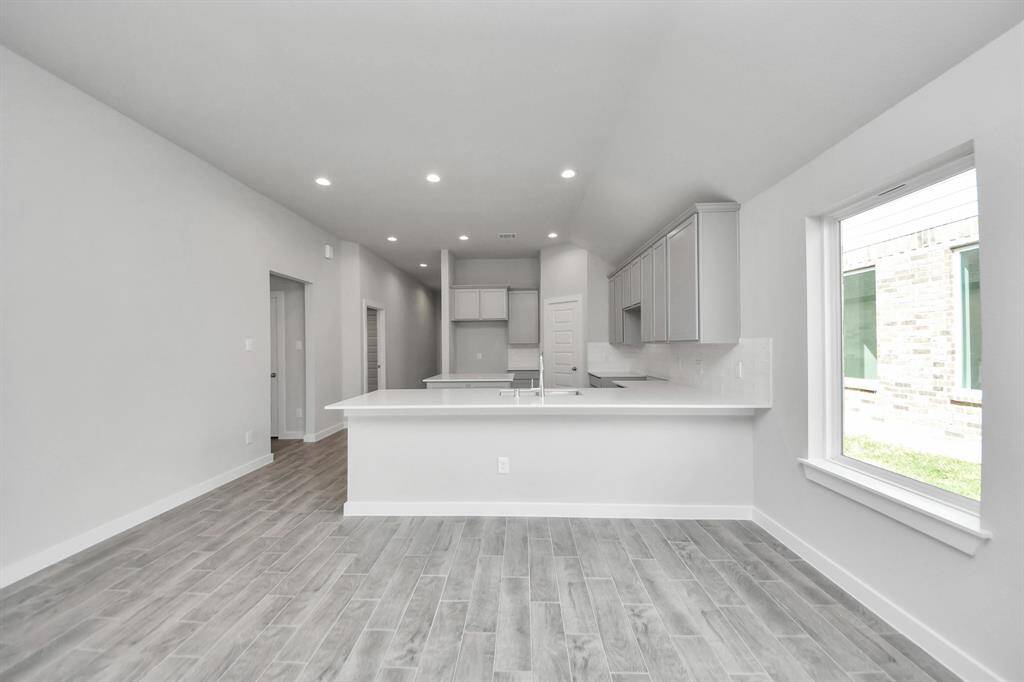 All of this overlooks your expansive family room, creating a perfect space for culinary delights and family gatherings.