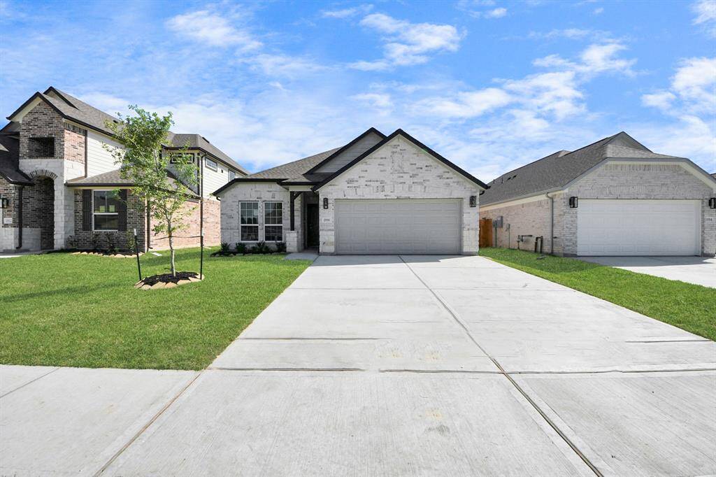 Behold a lush landscape, impeccably maintained yard, and a premium elevation adorned with captivating brick and stone features.